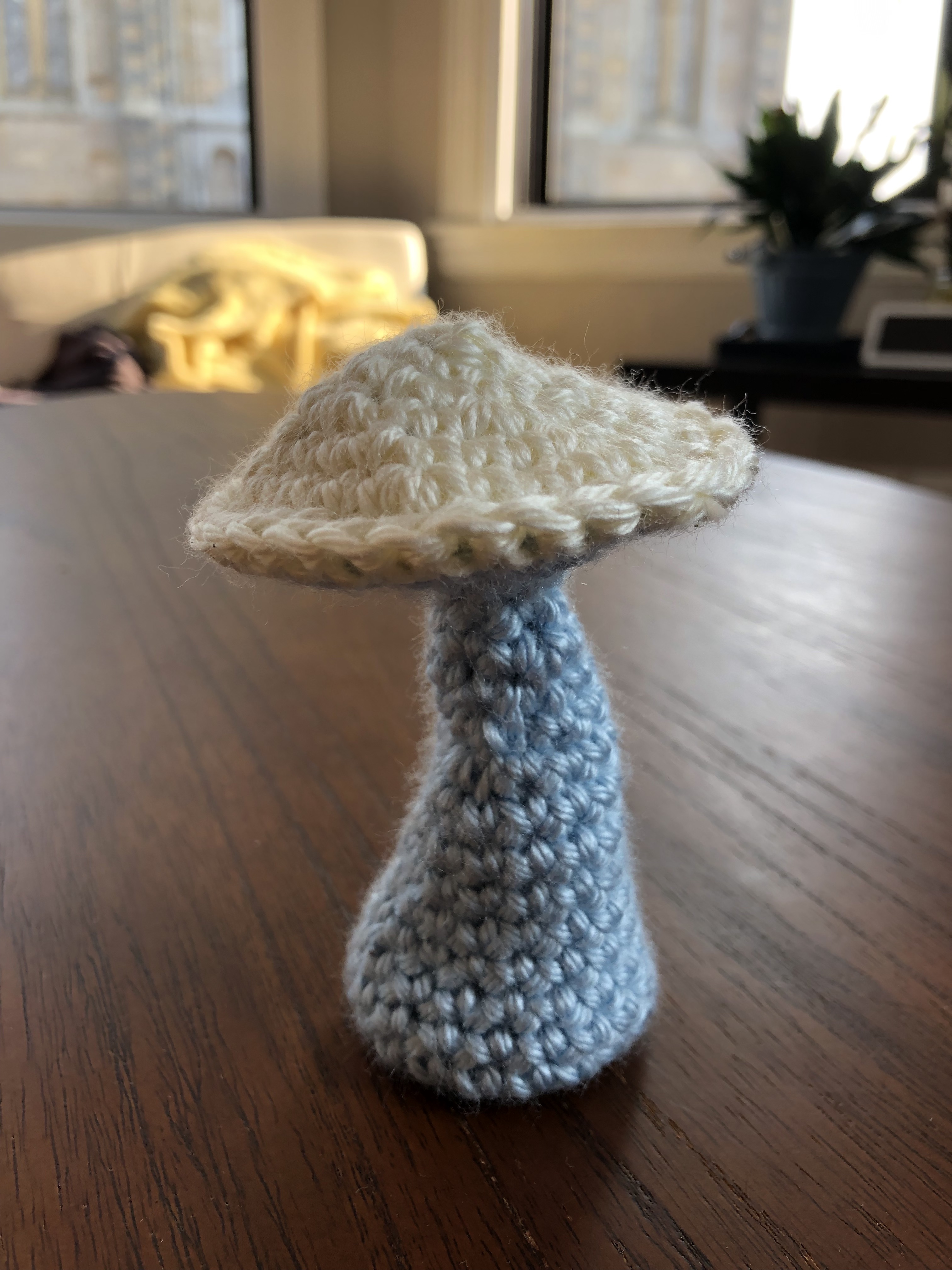 a mushroom with a white stem and blue base